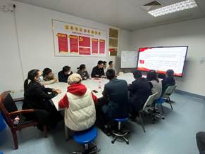 A group of people sitting in a room looking at a screenDescription automatically generated with medium confidence